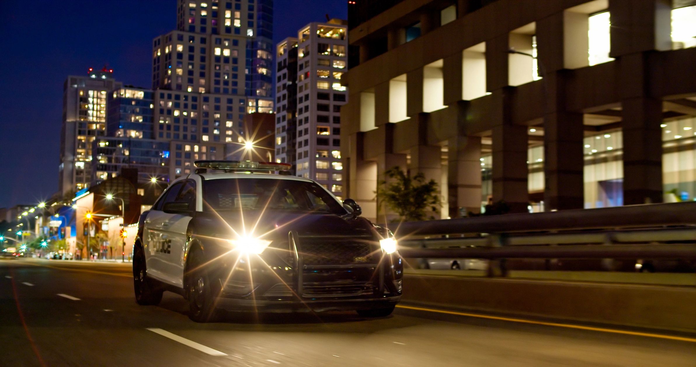 Porsche 911 rear view driving through the city at night