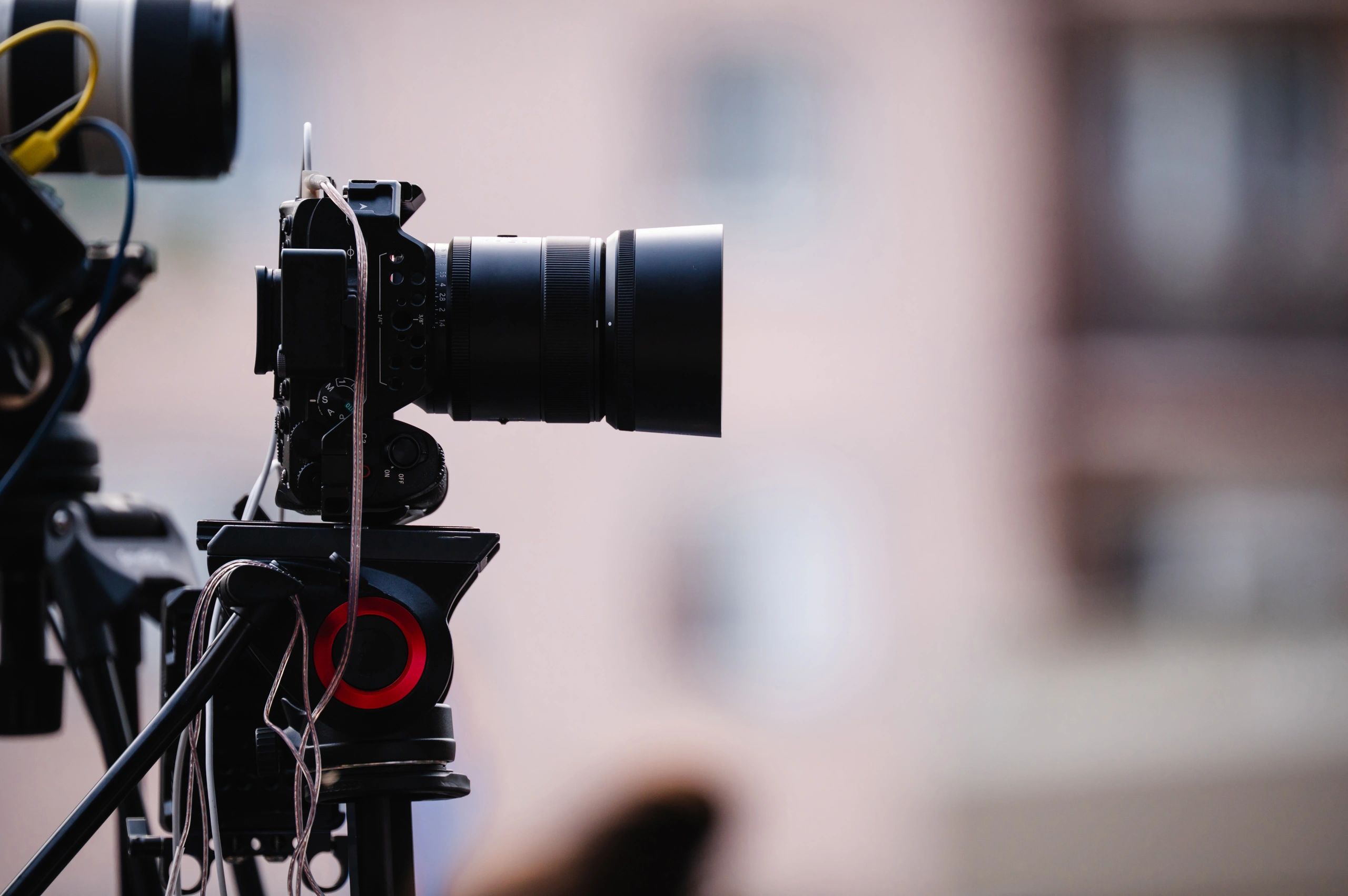 Professional video camera setup on tripod outdoors