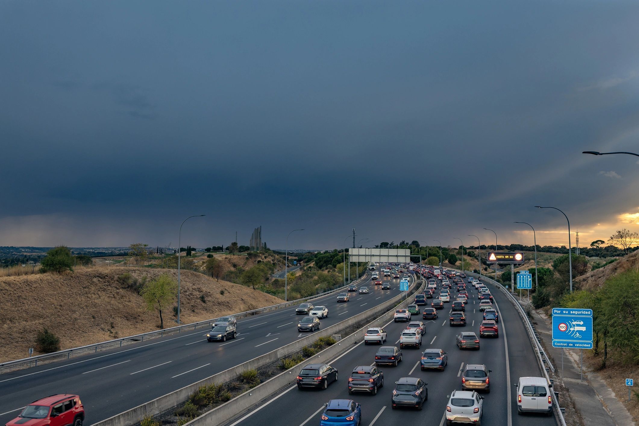 Highway traffic jam under dramatic storm sky
