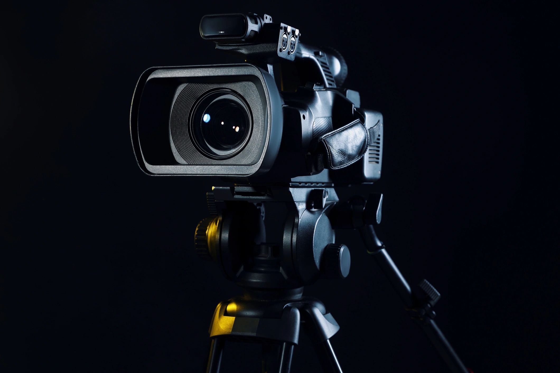 Modern video camera close-up on black background