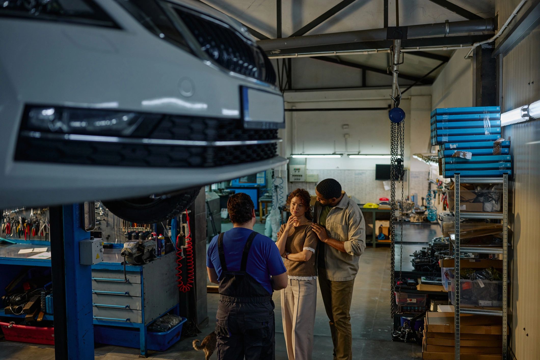 Team consulting in an auto garage for testimonial context